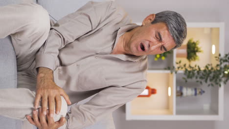 Vertical-video-of-The-man-is-suffering-from-joint-pain.